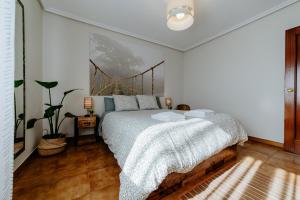 a bedroom with a bed and a painting on the wall at Casa Raíces de PO in Lapoblación