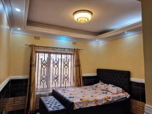 a bedroom with a bed and a window at Golden View Guest House in Lilongwe