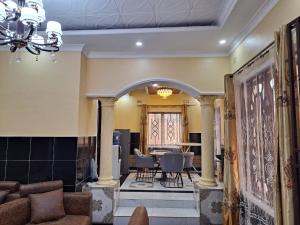 a living room with a table and chairs at Golden View Guest House in Lilongwe