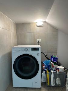 a washing machine in a corner of a room at Bujtina cela in Berat