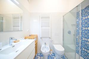 a bathroom with a sink and a toilet and a shower at La Casa del Mozzo in Ischia +15 photos
