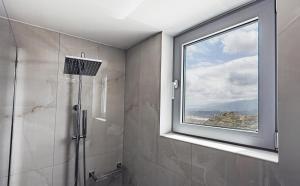 a bathroom with a shower and a window at Liopetro in Sitia +22 photos