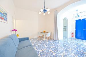 a living room with a blue couch and a table at La Casa del Mozzo in Ischia