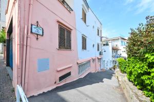 a pink and white building on a street at La Casa del Mozzo in Ischia