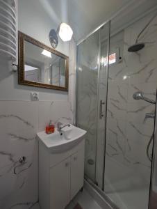 a bathroom with a sink and a shower with a mirror at Agroturystyka Szerokopaś in Nidzica +34 photos