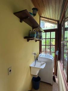 a bathroom with a sink and a toilet at Sitio vale das araucarias in Araras Petropolis +21 photos