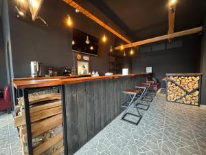 a bar in a restaurant with stools at a counter at Family Hotel in Batumi