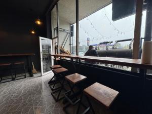 a bar with wooden stools in a restaurant with a view at Family Hotel in Batumi