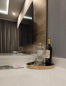 a tray with wine bottles and glasses on a counter at TeMax Lux Hahnenklee in Goslar +8 photos