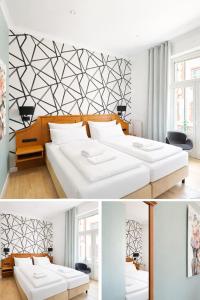 a bedroom with two beds and a black and white wall at Hotel Porta Nigra VICTUS in Trier