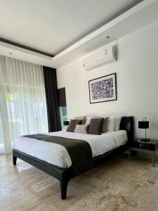 a bedroom with a large bed and a large window at Baan Tai Tara 4, Private Pool Villa by Ban Tai Beach in Ban Tai +56 photos