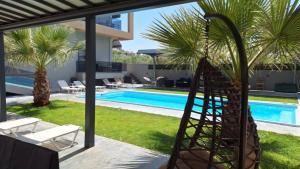 a view of a swimming pool from a house at Luana Monte Apartments in Amoudara Herakliou