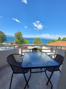 a table and chairs on a balcony with a view of the ocean at Villa Chaloski in Peštani