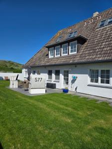 a house with a sign in front of a yard at Villa am Meer in Westerland