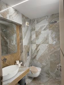 a bathroom with a white sink and a toilet at Blue Dreams in Keramoti +146 photos
