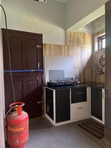a kitchen with a counter and a stove in it at Grass root by shelters in Vayittiri