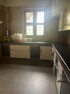 a kitchen with a counter top and a window at Grass root by shelters in Vayittiri +6 photos