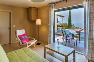 a living room with a couch and a table at Eltheo Villas in Agios Nikitas