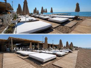 a row of chaise lounges on a beach with umbrellas at Leaf River Suites in Antalya