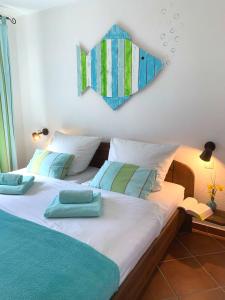a bedroom with a bed with blue and green pillows at Haus Seeblick in Dahme