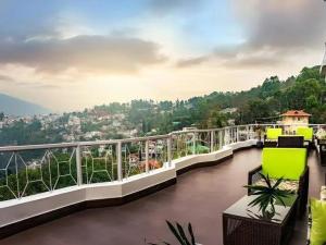 a balcony with a view of a river at Lillium Hotel & Spa in Kalimpong