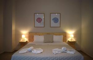 a bedroom with a bed with towels on it at Red Rose Garden in Tsilivi