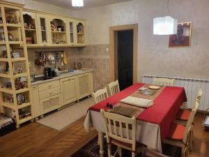 a kitchen and dining room with a table and cabinets at Green Oasis in Danilovgrad
