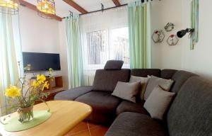 a living room with a couch and a table at Haus Seeblick in Dahme