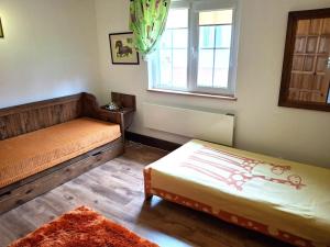 a room with two beds and a window at Białowieska Przystań in Białowieża