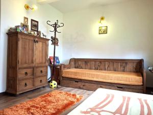 a bedroom with a bed and a wooden dresser at Białowieska Przystań in Białowieża