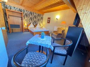 a hotel room with a bed and a table and chairs at RS Aparthotel in Schöppenstedt