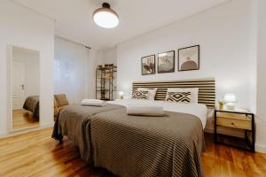 a white bedroom with a large bed and a desk at Alojamiento en pleno centro con WIFI y Aire Acondicionado in Logroño +23 photos