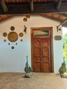 a room with a door and some plates on the wall at Karisal Resort & Park in Jaffna