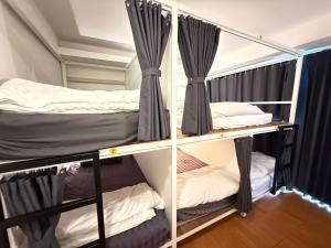 two bunk beds in a room with curtains at THE BEST ONE CHIANG MAI in Chiang Mai