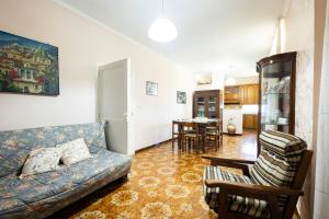 a living room with a couch and a dining room at Casa Vacanza Capozzoli in Albanella