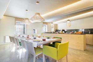 a large kitchen with a long table and chairs at Set Terres - La Villa de Ll&iacute;via - Adults only in Llivia
