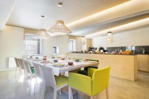 a large kitchen with a long table and chairs at Set Terres - La Villa de Llívia - Adults only in Llivia