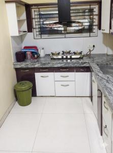 a kitchen with a stove and a counter top at Shivlok Homestay in Ujjain