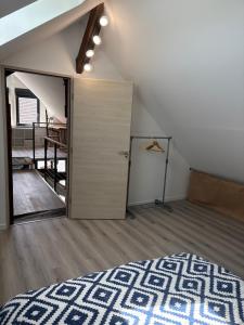 an attic room with a closet and a door at La Fraternelle in Ceyzérieu