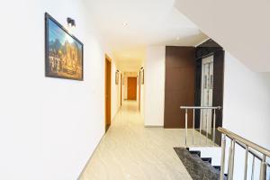 a hallway with stairs and a painting on the wall at FabHotel Sahyadri Mantram in Pune