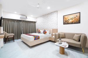a hotel room with a bed and a couch at FabHotel Sahyadri Mantram in Pune