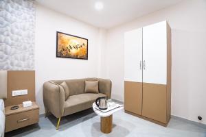 a living room with a chair and a table at FabHotel Sahyadri Mantram in Pune