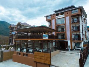 a building with a restaurant in front of it at Walnut Village Resort in Pahalgām