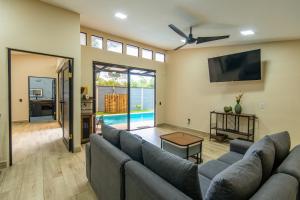 a living room with a couch and a tv at Villa Libe Puerto Viejo in Puerto Viejo