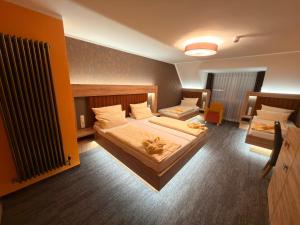a large bedroom with two beds and a radiator at Heidekönig Hotel Celle in Celle
