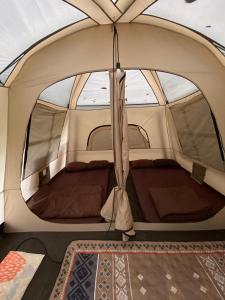 a tent with a bed inside of it at Pakis Camping Cikole in Tangkubanperahu +10 photos