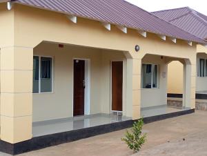 a small house with a porch at Wayekha Hotels in Kasungu