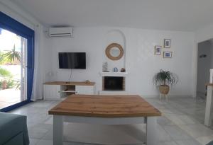 a living room with a table and a tv at El sueño de Rocío in Roquetas de Mar