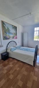 a bedroom with a large bed in a room at Résidence Aiko CÔTIERS in Mahébourg +54 photos