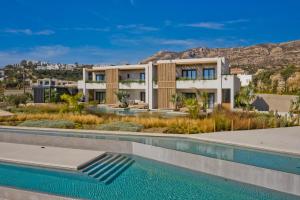 an image of a house with a swimming pool at Almi Luxury Rooms in Amoopi